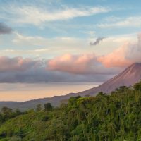 Arenal Volcano at Sunrise in Costa Rica, as the sun reflects on the newly formed clouds